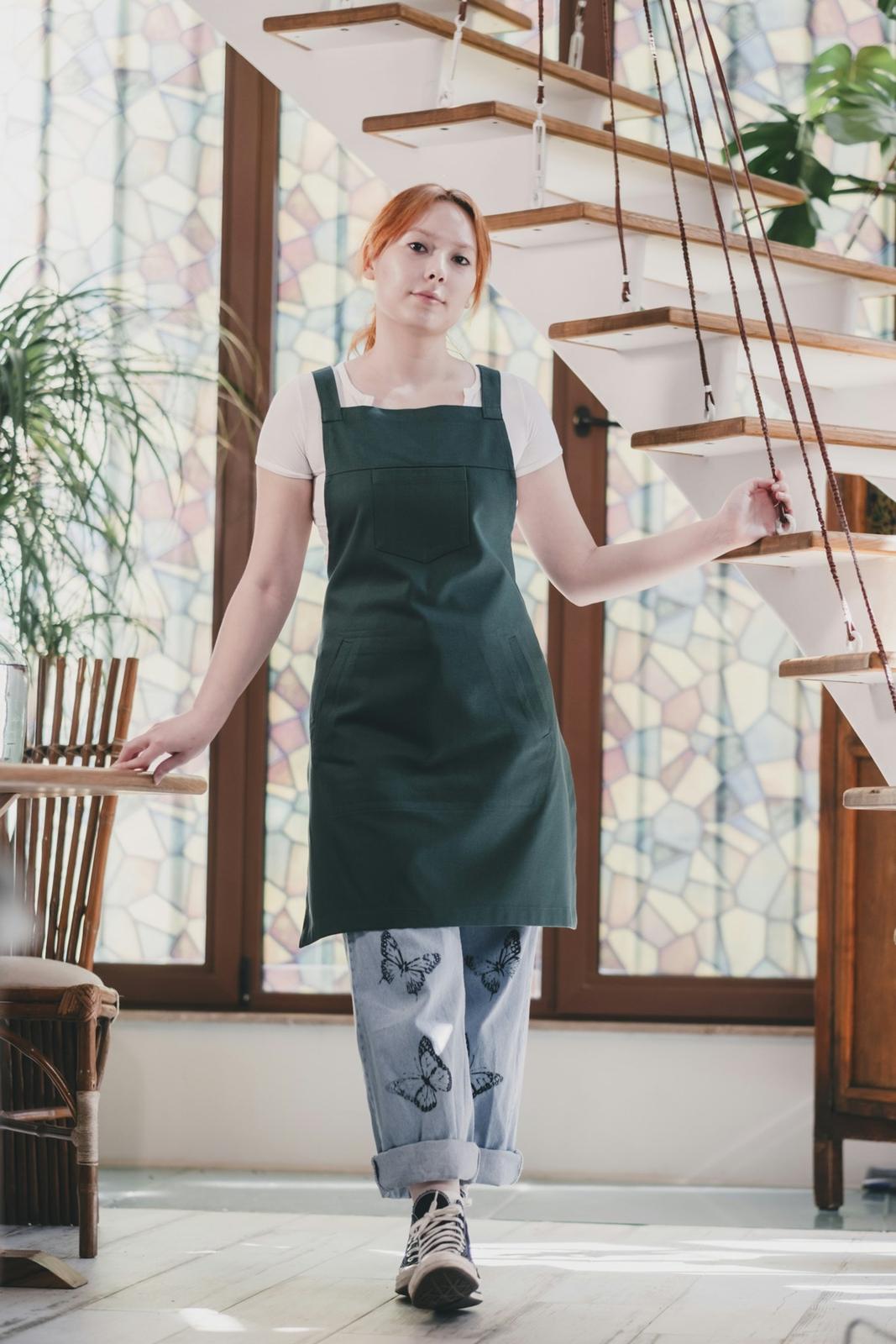 Bea in a green apron in her kitchen