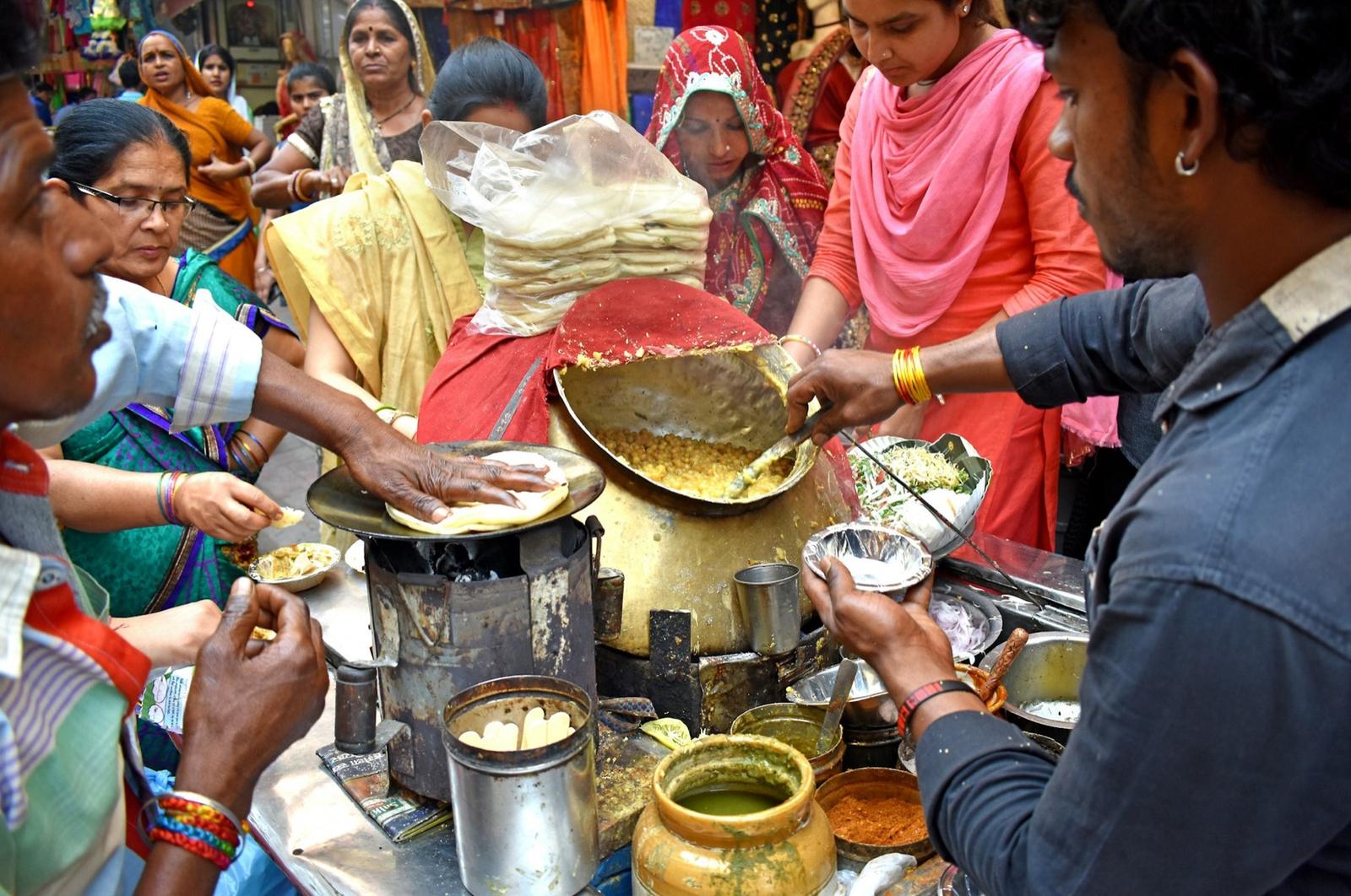 Guests crowding a live chaat counter at a wedding